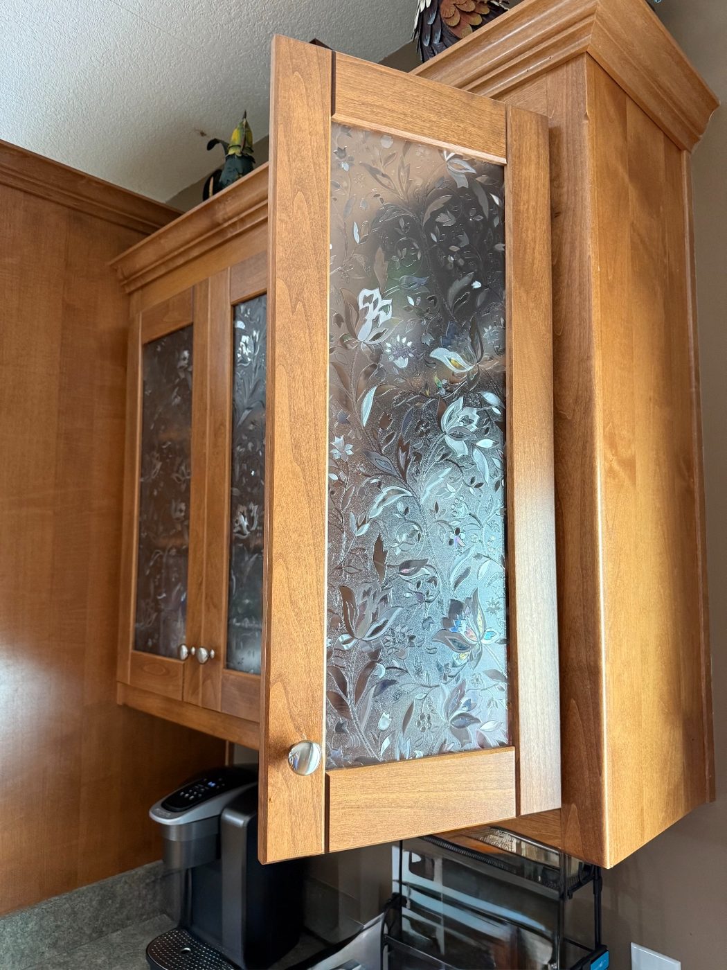 Same cabinet doors with decorative floral textured glass after the upgrade