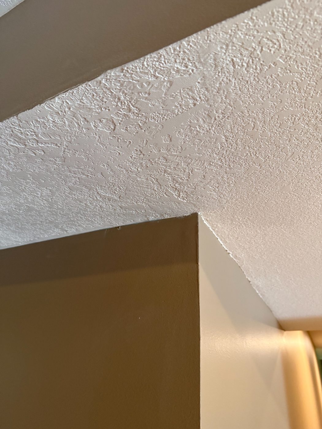 Finished ceiling repair with matching texture, crack no longer visible