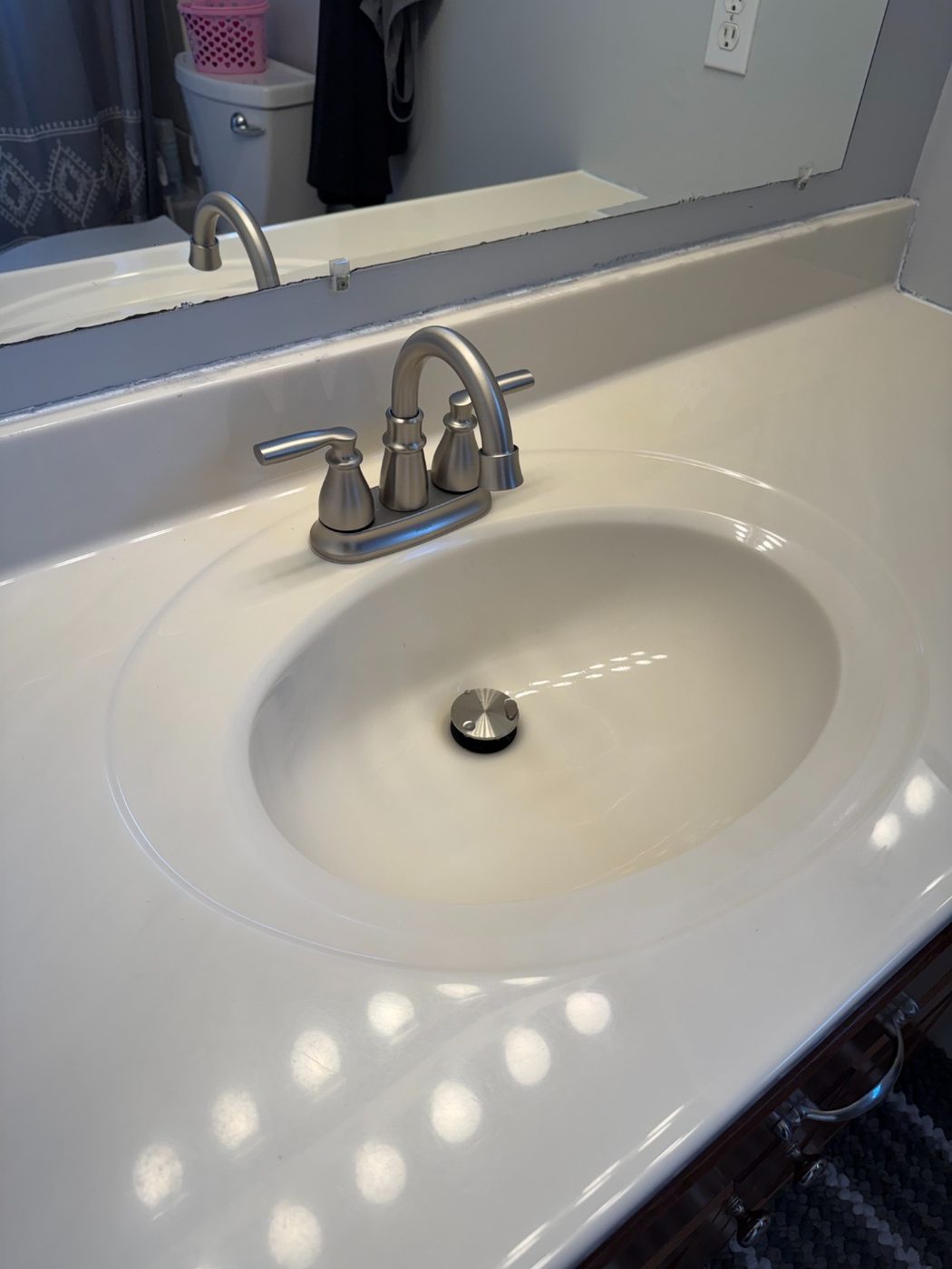 Close-up of the new brushed nickel bathroom faucet after the update