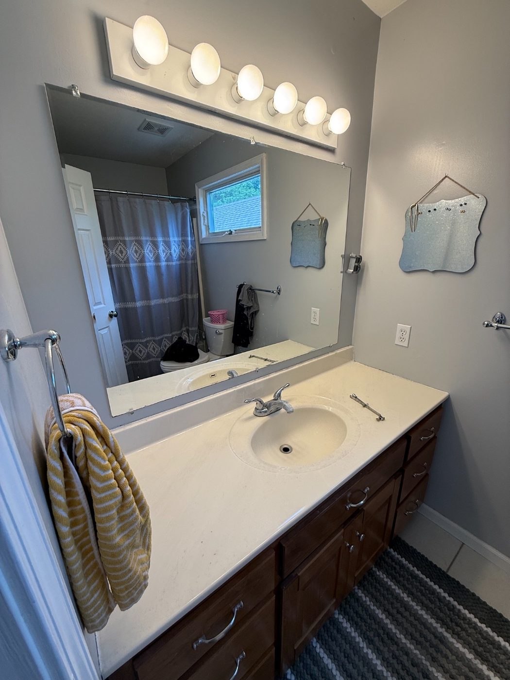 Bathroom vanity with old worn chrome faucet before the update