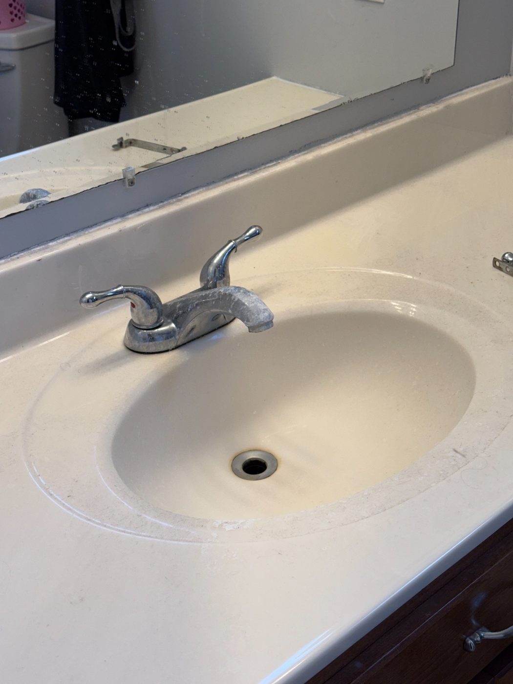 Close-up of the old corroded chrome bathroom faucet before the update